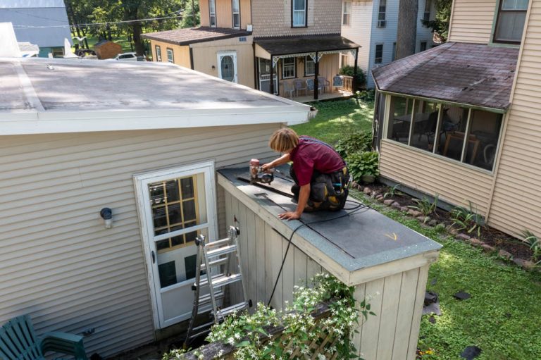 amish man repairing roof